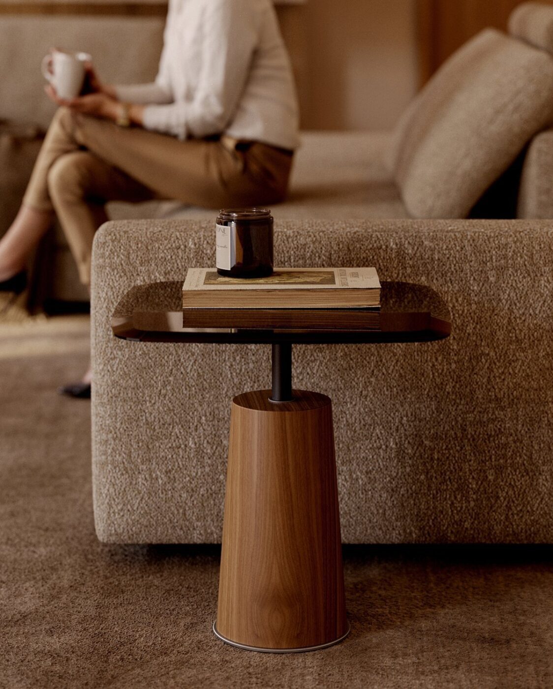 Panton Side Table - Autumn Panton side table in wood and glass beside Edward sofa. The side table has a book and a candle on the top of the glass.